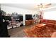 Spacious living room with ample shelving, large TV, comfortable sofa, and eye-catching rug at 126 Fleming Dr, Statesville, NC 28677