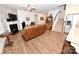 Spacious living room has wood floors, leather sofa, fireplace, and a staircase to upper level at 126 Fleming Dr, Statesville, NC 28677