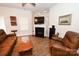 Comfortable living room boasts a fireplace, wood floors, and cozy leather furniture at 126 Fleming Dr, Statesville, NC 28677