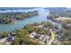 Stunning aerial view of waterfront community with lush trees and lake views and community pool at 3067 Trace Meadow Ct, York, SC 29745