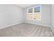 Well-lit bedroom featuring plush carpet flooring and bright window at 3067 Trace Meadow Ct, York, SC 29745