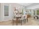 Elegant dining room featuring a modern chandelier, light wood floors, and ample space for entertaining guests at 3067 Trace Meadow Ct, York, SC 29745