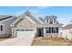 Charming home featuring stone and shingle siding, front porch and two-car garage at 3067 Trace Meadow Ct, York, SC 29745