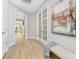 Bright hallway featuring a glass paneled door, neutral walls, and light wood floors enhancing the home's inviting appeal at 3067 Trace Meadow Ct, York, SC 29745