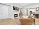 Open-concept living room featuring a fireplace, light wood floors, and seamless transition to the kitchen and dining area at 3067 Trace Meadow Ct, York, SC 29745