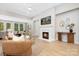 Inviting living room featuring a cozy fireplace, light wood floors, and ample natural light creating a warm ambiance at 3067 Trace Meadow Ct, York, SC 29745