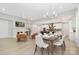Open-concept living space featuring a fireplace, dining area, and modern kitchen, with light wood floors throughout at 3067 Trace Meadow Ct, York, SC 29745