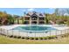 Community pool with fence surrounded by lush trees and lawn at 3067 Trace Meadow Ct, York, SC 29745