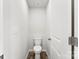 Small powder room with toilet and tile floor at 4915 Raspberry Knoll Dr, Charlotte, NC 28208