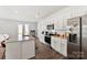 Modern kitchen with white cabinets, granite countertops, and stainless steel appliances at 4915 Raspberry Knoll Dr, Charlotte, NC 28208