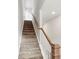 Carpeted staircase with wooden handrail and white balusters at 4915 Raspberry Knoll Dr, Charlotte, NC 28208