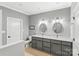 Double vanity bathroom with gray cabinets and oval mirrors at 119 42Nd Avenue Nw Dr, Hickory, NC 28601