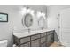 Double vanity bathroom with gray cabinets and oval mirrors at 119 42Nd Avenue Nw Dr, Hickory, NC 28601