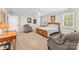 Spacious bedroom with a wooden bed frame, two armchairs, and window shutters at 119 42Nd Avenue Nw Dr, Hickory, NC 28601