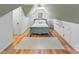 Charming attic bedroom with a light teal bed frame and hardwood floors at 119 42Nd Avenue Nw Dr, Hickory, NC 28601