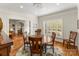 Bright dining room features hardwood floors, a wooden table with chairs, and plantation shutters at 119 42Nd Avenue Nw Dr, Hickory, NC 28601