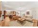 Living room with hardwood floors, a fireplace, and an open kitchen at 119 42Nd Avenue Nw Dr, Hickory, NC 28601