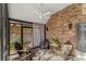 Spacious screened porch with wooden chairs and brick wall at 119 42Nd Avenue Nw Dr, Hickory, NC 28601