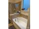 A bathtub with tile surround and a shelf with books and decor near the window at 129 Johnson Manor St, Mooresville, NC 28115