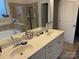 Elegant bathroom featuring double sinks, a large mirror, and tiled shower and tub areas at 129 Johnson Manor St, Mooresville, NC 28115