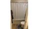 Bathroom with a white shower curtain, toilet, and tan tile floors at 129 Johnson Manor St, Mooresville, NC 28115