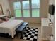Relaxing bedroom with large windows, a cozy bed, and modern amenities for ultimate comfort at 129 Johnson Manor St, Mooresville, NC 28115