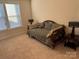 Bright bedroom with a striped daybed, complemented by two stylish lamps and ample natural light from the window at 129 Johnson Manor St, Mooresville, NC 28115