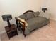 Cozy bedroom featuring a comfortable daybed with accent pillows and a decorative side table with a lamp at 129 Johnson Manor St, Mooresville, NC 28115