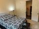 Inviting bedroom with a comfortable bed, stylish bedding, and convenient access to the closet at 129 Johnson Manor St, Mooresville, NC 28115