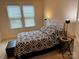 Serene bedroom with natural light streaming through the window and stylish side tables at 129 Johnson Manor St, Mooresville, NC 28115