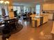 Open-concept kitchen with a granite island, stainless steel appliances, and seamless flow into the living area at 129 Johnson Manor St, Mooresville, NC 28115