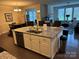 Open-concept kitchen boasts granite countertops, stainless steel appliances and overlooks the living area at 129 Johnson Manor St, Mooresville, NC 28115