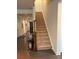 Staircase has carpeted steps, wooden banister, and landing table with decorative vases for added elegance at 129 Johnson Manor St, Mooresville, NC 28115