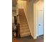 Carpeted staircase with wooden railing provides a seamless transition to the upper level, enhancing the home's flow at 129 Johnson Manor St, Mooresville, NC 28115