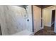 Spa-like bathroom with marble shower, dark accents and wood-look flooring at 1703 Polk St, Monroe, NC 28110