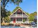 Two-story house with a gray exterior, red door, and wrap-around porch at 1703 Polk St, Monroe, NC 28110