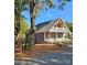 Gray house with white trim, a red door, and a wraparound porch at 1703 Polk St, Monroe, NC 28110