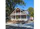 Two-story house with a gray exterior, red door, and wrap-around porch at 1703 Polk St, Monroe, NC 28110