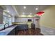 Modern kitchen with gray and white cabinets and a red pendant light at 1703 Polk St, Monroe, NC 28110