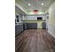 L-shaped kitchen with gray cabinets, stainless steel appliances, and laminate flooring at 1703 Polk St, Monroe, NC 28110