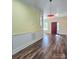 Bright living room with hardwood floors, large windows, and a red door at 1703 Polk St, Monroe, NC 28110