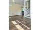 Living room with hardwood floors, a staircase, and a view of the kitchen at 1703 Polk St, Monroe, NC 28110