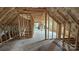 Unfinished attic space with framed walls and insulation at 1703 Polk St, Monroe, NC 28110