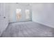 Bright bedroom with neutral carpeting and two windows at 2208 Noble Townes Way, Charlotte, NC 28262