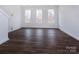 Bright room with hardwood floors and multiple windows at 2208 Noble Townes Way, Charlotte, NC 28262