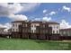 Row of townhomes with brick and white siding at 2208 Noble Townes Way, Charlotte, NC 28262