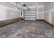 Unfinished garage with overhead door and concrete floor at 2208 Noble Townes Way, Charlotte, NC 28262