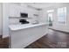 Modern kitchen with white cabinets and a large island at 2208 Noble Townes Way, Charlotte, NC 28262