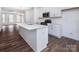 Modern kitchen with island, stainless steel appliances, and hardwood floors at 2208 Noble Townes Way, Charlotte, NC 28262