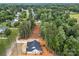 An aerial view of a new construction home with a dark gray roof amidst a lush, green, wooded landscape at 315 Bonaventure Dr, Salisbury, NC 28147